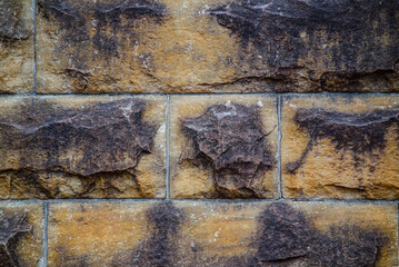 Old sandstone wall texture with the abstract pattern.