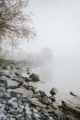 Rocky beach of Lake Ontario on a gray foggy day.
