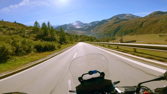 A highway motorcycle ride on a sunny summer day, at the Simplon Pass in Switzerland.