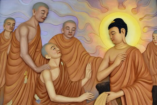 A wall mural depicting Buddha with long earlobes and Buddhist monks with shaves heads and orange robes
