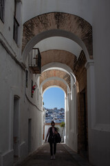 Fototapeta na wymiar Woman walking through a white village in Andalusia