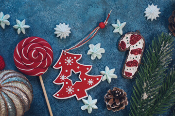 Christmas decorations background with fir branches, candies, mittens and corn on turquois table