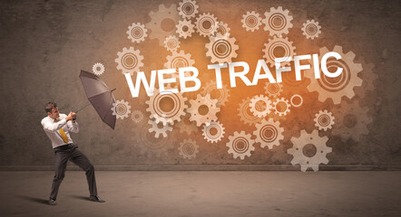 Obraz premium Businessman defending with umbrella concept