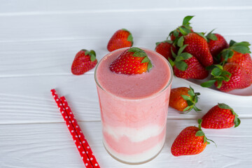 Strawberry yogurt fruit juice smoothie pink colorful fruit juice milkshake blend beverage healthy high protein the taste yummy In glass drink episode morning on white wood background.