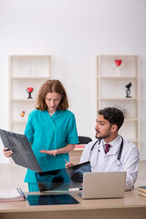 Young male doctor radiologist and female assistant working in th
