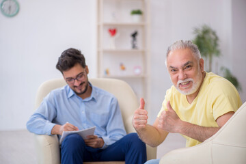 Old man visiting young male psychotherapist