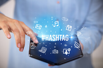 Businessman holding a foldable smartphone, social media concept concept