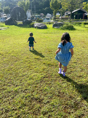 Fototapeta premium Siblings taking a walk in the park
