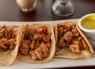 Close up of mexican chicken tacos, chicken tacos with salsa served on the table, tacos served on the table
