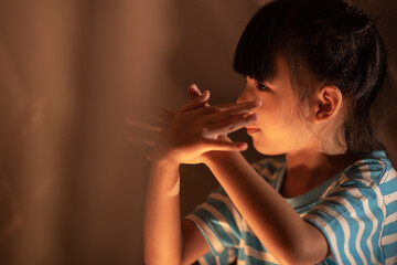 young Asian mother with little child daughter family happy in cozy night light at childhood home