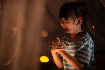 young Asian mother with little child daughter family happy in cozy night light at childhood home