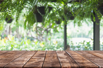 Empty wood table top and blurred green tree and fruit vegetable in agricultural farms background -...