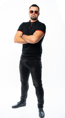 Naklejka premium portrait of a man in a black t-shirt and jeans in the studio. pumped up Italian macho. isolated white background