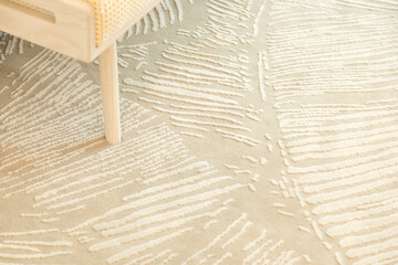 Close up of carpet by the bed, close up near the bed and the bench.
