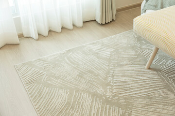 Close up of carpet by the bed, close up near the bed and the bench.