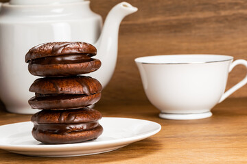 Closeup view stack of choco pie and a cup of hot tea.
