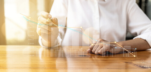 A business man examines data on financial documents, company financial reports, graphics showing financial and numerical growth data. The concept of financial management to grow and be profitable.
