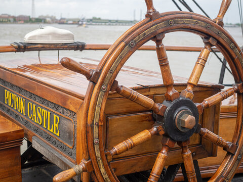 Steering Wheel on Tall Ship Picton Castle Docked in Mississippi River by Woldenberg Park on April 21, 2018 in New Orleans, LA, USA