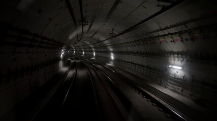 Back cabin view of driverless metro train moving through underground tunnel. Automated advanced transportation system, subway in Madrid, Spain