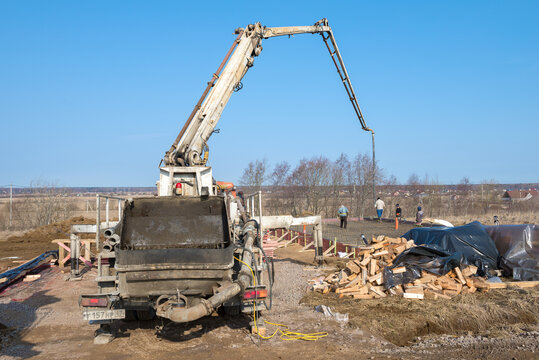 LENINGRAD OBLAST, RUSSIA - MARCH 28, 2021: Concrete pump on the construction site of a country house on a sunny March day