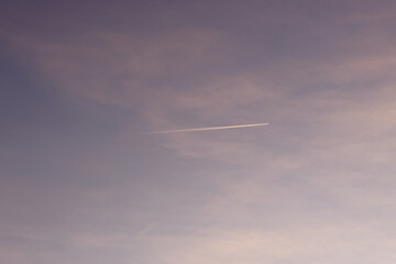 smoke trails from airplanes flying across clear skies