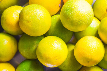 Tasty and fresh lime fruits or oranges background. Organic food.