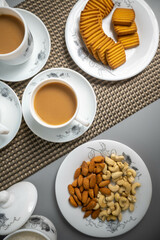 Tea time with Biscuits and dry fruits, White Plan Cashew, and Almonds.
seave in the white marble Tea set. 