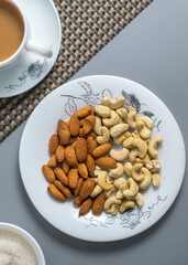 Tea time with Biscuits and dry fruits, White Plan Cashew, and Almonds.
seave in the white marble Tea set. 