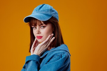 Portrait of a charming lady denim clothing fashion posing cap color background unaltered