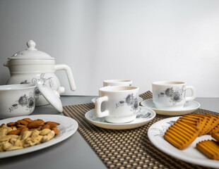 Tea time with Biscuits and dry fruits, White Plan Cashew, and Almonds.
seave in the white marble Tea set. 