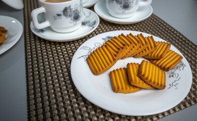 Tea time with Biscuits and dry fruits, White Plan Cashew, and Almonds.
seave in the white marble Tea set. 