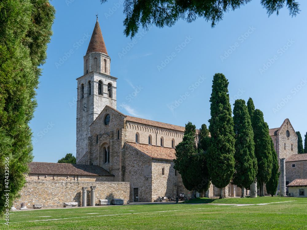 Wall mural Basilica of Aquileia with cypress trees, and lawn in the foreground