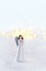 cute angel figurine on abstract light background. faith in God, Christianity church, prayer, lent,...