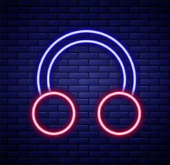 Glowing neon line Piercing icon isolated on brick wall background. Colorful outline concept. Vector