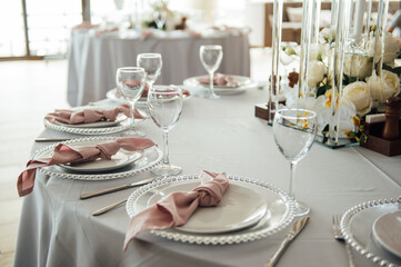 Luxurious restaurant. Luxurious interior, white tables, serving dishes and glasses for guests