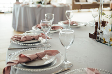Luxurious restaurant. Luxurious interior, white tables, serving dishes and glasses for guests