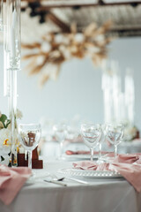 Luxurious restaurant. Luxurious interior, white tables, serving dishes and glasses for guests