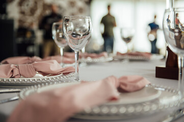 Luxurious restaurant. Luxurious interior, white tables, serving dishes and glasses for guests
