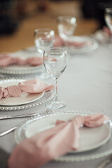 Luxurious restaurant. Luxurious interior, white tables, serving dishes and glasses for guests