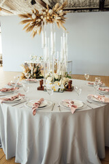 Luxurious restaurant. Luxurious interior, white tables, serving dishes and glasses for guests