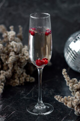 A glass of white wine on dark background