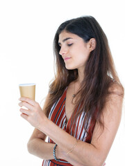 Attractive girl is holding looking brown carton cup hot drink coffee of tea pensive woman relax