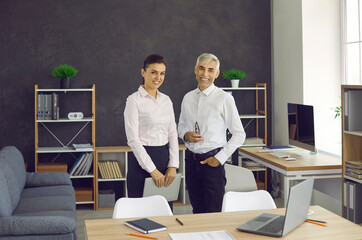 Happy confident smiling team manager and employee together. Portrait of two happy successful business people, company owners. Business, professional job and success concept