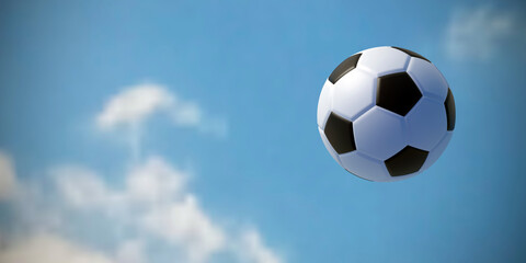 Soccer ball flies against the blue sky