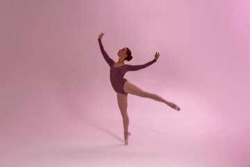 Fototapeta na wymiar Elegant fit girl dancing ballet dance in studio