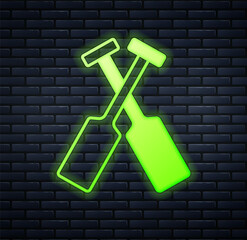 Glowing neon Crossed oars or paddles boat icon isolated on brick wall background. Vector