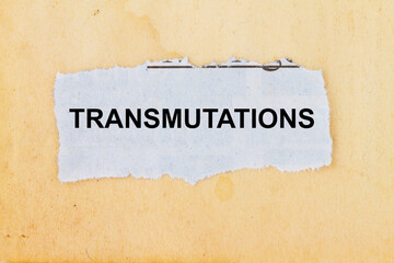 Transmutations tear on a pge of newspaper with vintage brown paper background
