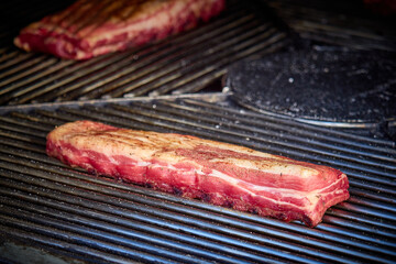 Large cuts of grilled meat with vegetables