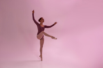 Fototapeta na wymiar Caucasian girl dancing ballet dance in studio
