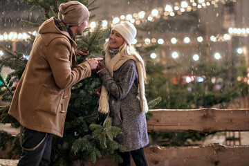 Man and woman choose the perfect Christmas tree